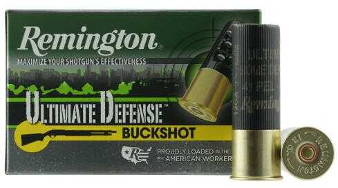 A box of Remington 12 Gauge 3 #4 Buck lead shotgun shells (5 rounds), with one shell upright and another lying in front. The green box features yellow and black accents—ideal for home defense.